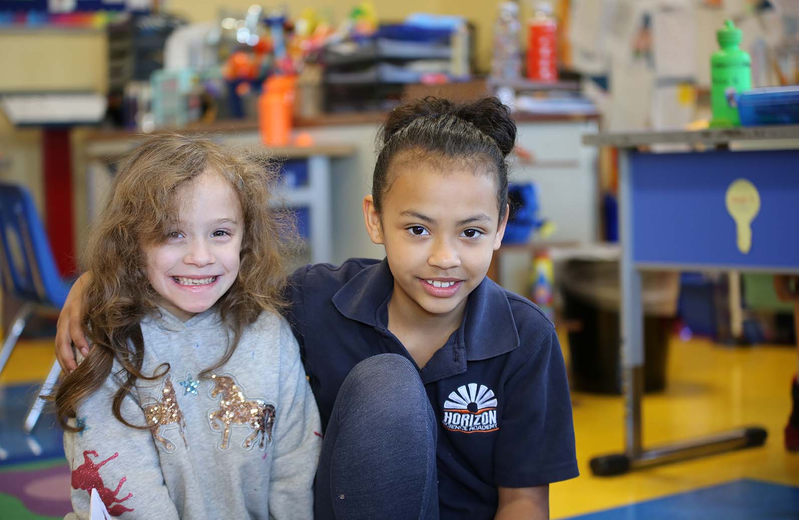Teacher or school staff member warmly interacting with a student outside
